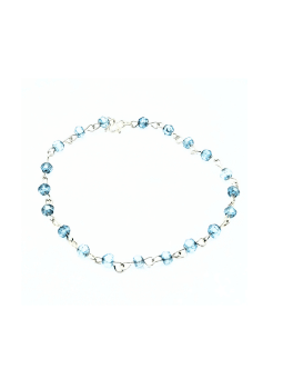 Delicate bracelet featuring 4 mm blue topaz gemstones, each individually wire-wrapped in sterling silver and linked together with a sterling silver clasp.