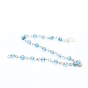 Delicate bracelet featuring 4 mm blue topaz gemstones, each individually wire-wrapped in sterling silver and linked together with a sterling silver clasp.