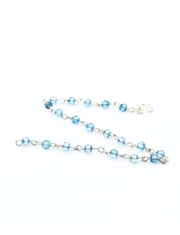 Delicate bracelet featuring 4 mm blue topaz gemstones, each individually wire-wrapped in sterling silver and linked together with a sterling silver clasp.