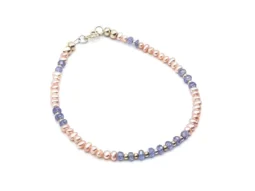 Delicate bracelet featuring 3 mm genuine tanzanite gemstones and peach freshwater pearls, accented with sterling silver spacers and clasp.