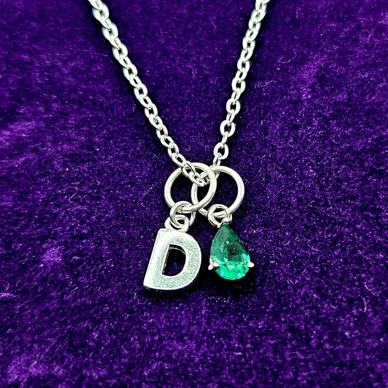 Chic May birthstone necklace featuring a vivid green crystal to represent emerald, paired with a sterling silver initial charm.