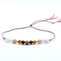 A nurturing fertility bracelet with moonstone, aquamarine, rhodonite, rose quartz, and unakite, accented with sterling silver on an adjustable pink silk cord. Designed to support fertility and emotional well-being.