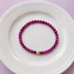 Red ruby bracelet with 18k gold filled accent bead, elastic construction