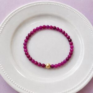 Red ruby bracelet with 18k gold filled accent bead, elastic construction