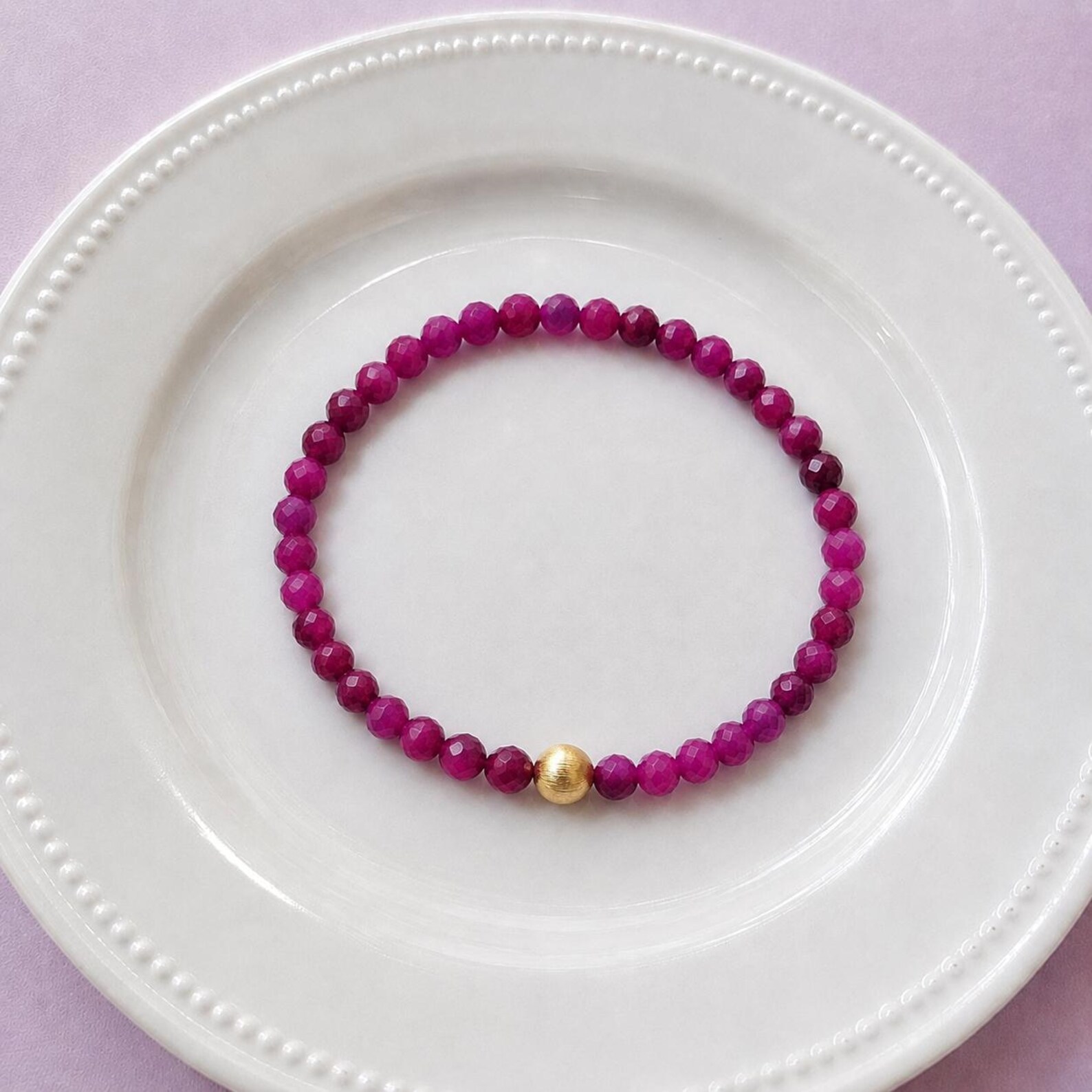 Red ruby bracelet with 18k gold filled accent bead, elastic construction